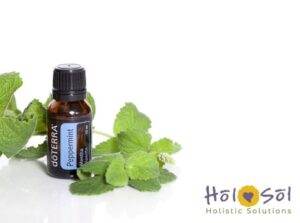 image of doterra peppermint essential oil with mint leaves on white background