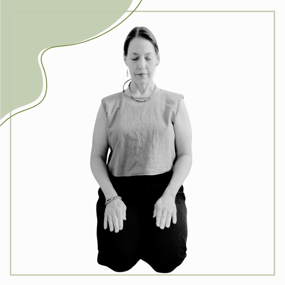 A woman sits on her knees with her hands resting on her thighs and her eyes closed, appearing calm, against a plain background with a green abstract accent.
